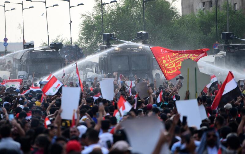 Iraqi riot police use water cannon in central Baghdad.  EPA