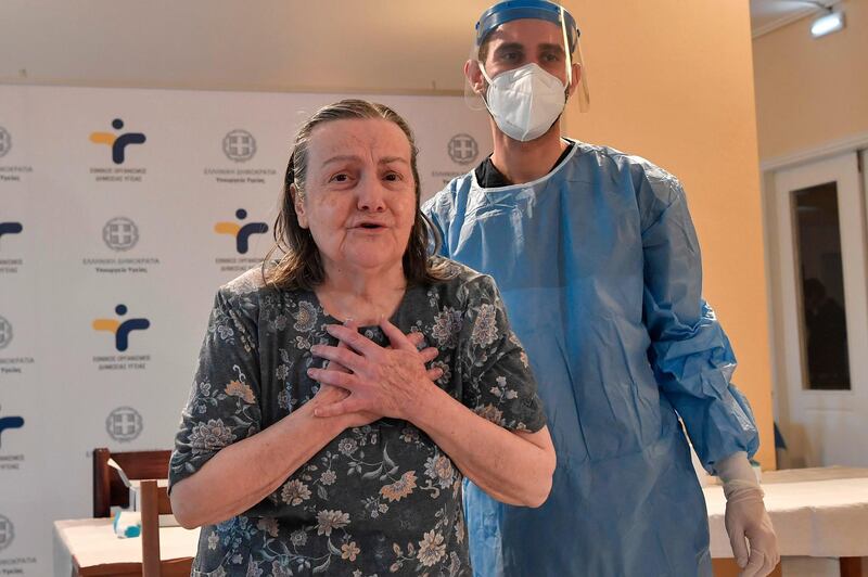 A woman shows gratitude after being vaccinated for Covid-19 in a nursing home in a north of Athens suburb in Greece. AFP