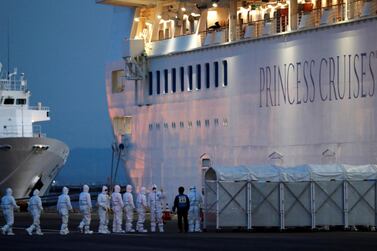 Officers in protective gear enter the cruise ship Diamond Princess, where 10 more people were tested positive for coronavirus on Thursday, to transfer a patient to the hospital after the ship arrived at Daikoku Pier Cruise Terminal in Yokohama, south of Tokyo, Japan February 7, 2020. REUTERS/Kim Kyung-Hoon REFILE - ADDING INFORMATION