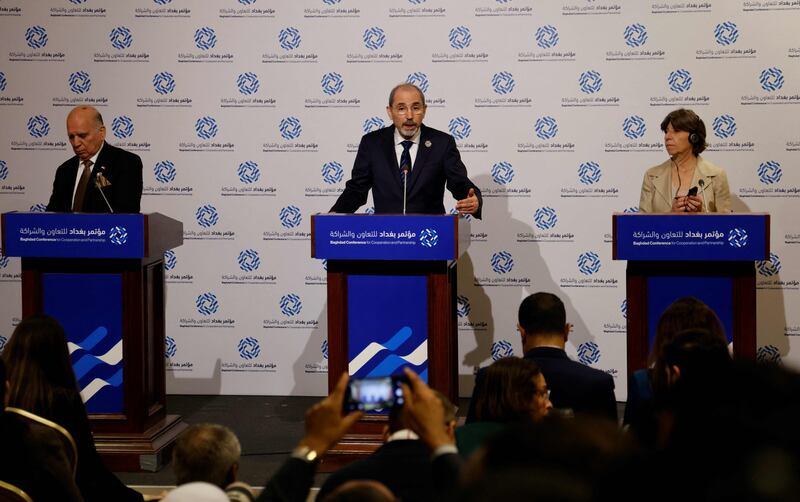Jordanian Foreign Affairs Minister Ayman Safadi, centre, and his Iraqi and French counterparts, Fouad Hussein and Catherine Colonna, field questions during a press conference at the conference. AFP