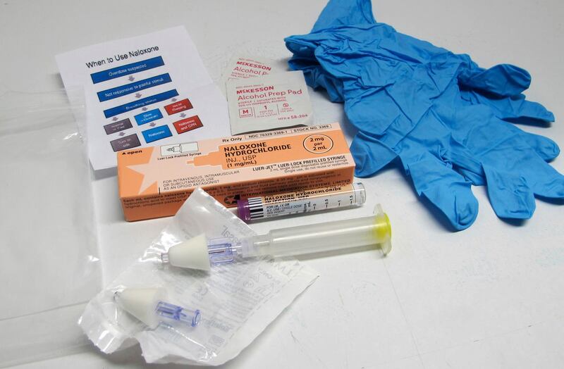 FILE - This May 13, 2015, file photo shows the contents of a drug overdose rescue kit at a training session on how to administer naloxone, which reverses the effects of heroin and prescription painkillers, in Buffalo, N.Y. Opioid poisonings and overdoses are sending rising numbers of U.S. kids to the hospital. That's according to a study also showing a surge in potentially life-threatening reactions. Prescription painkillers were often involved, but heroin and other opioids also were used. (AP Photo/Carolyn Thompson, File)