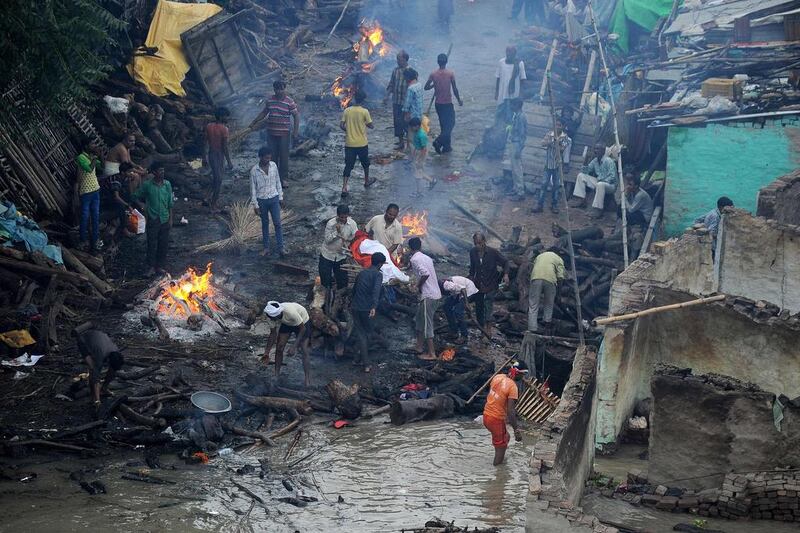 Indian people hold cremations along a roadside following heavy flooding at Daraganj ghat near Sangam in Allahabad. Sanjay Kanojia / AFP Photo