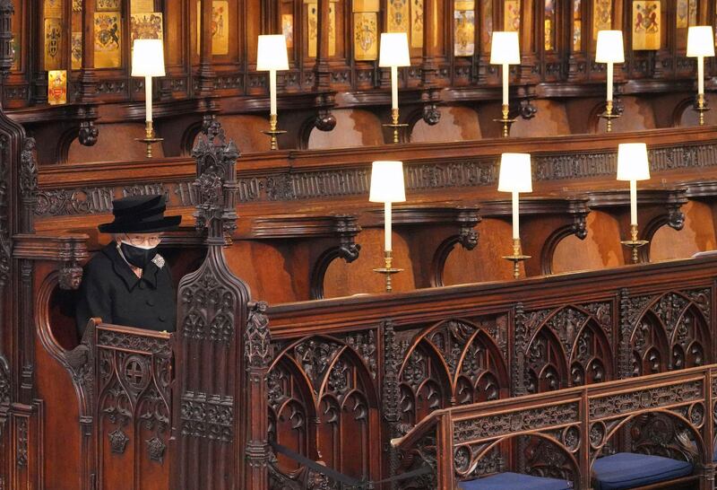 Britain's Queen Elizabeth II looks on as she sits alone in St. Georgeâ€™s Chapel during the funeral of Prince Philip, the man who had been by her side for 73 years, at Windsor Castle, Windsor, England, Saturday April 17, 2021. Prince Philip died April 9 at the age of 99 after 73 years of marriage to Britain's Queen Elizabeth II. (Jonathan Brady/Pool via AP)