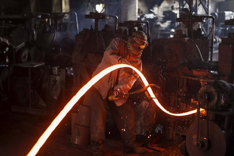 A worker bends a hot iron rod at a factory in Islamabad. Mian Khursheed / Reuters