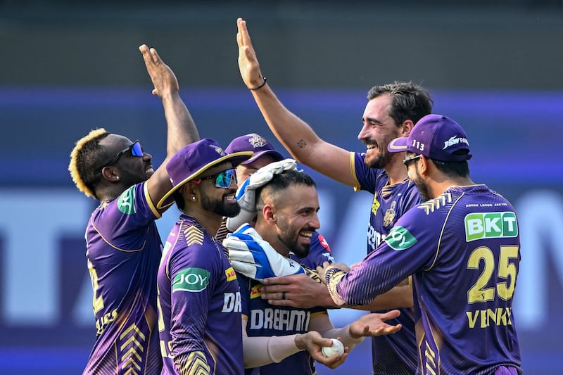 Kolkata Knight Riders' Mitchell Starc, second right, celebrates with teammates after taking the wicket of Lucknow Super Giants' Deepak Hooda, caught by Ramandeep Singh for 8 runs. AFP
