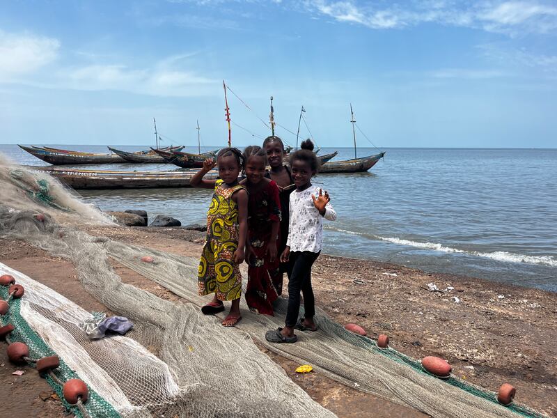 These girls may be too young to join the community’s fishing boats, but they help by untangling and repairing snagged  nets. Nick Webster / The National