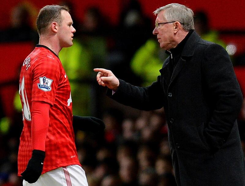 Wayne Rooney shown with Alex Ferguson during a Premier League match in January 2013 during their final season together at Manchester United. Andrew Yates / AFP / January 30, 2013
