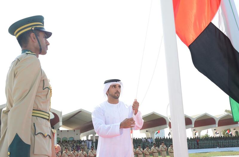 Sheikh Hamdan raises the UAE flag for Dubai Police. Courtesy Dubai Police