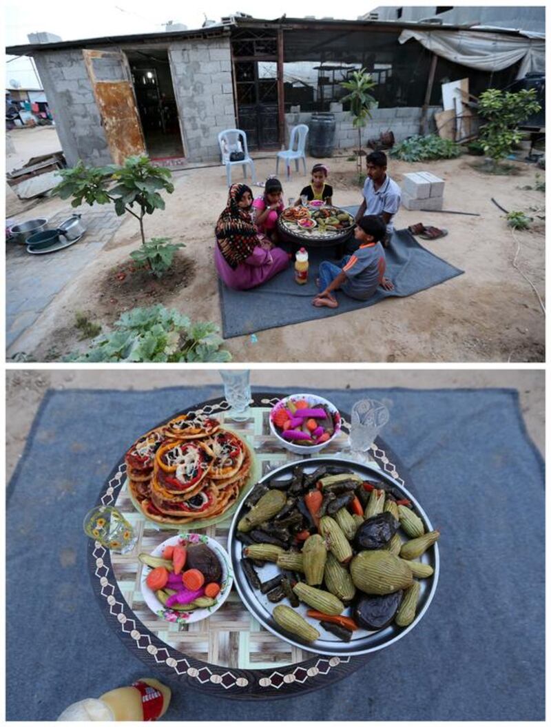 A Palestinian family as they wait to break their fast together outside their shelter in Khan Younis, in the southern Gaza Strip on June 14, 2016. Photo by Ibraheem Abu Mustafa