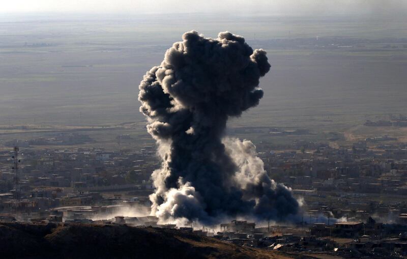 (FILES) In this file photo, Heavy smoke billows during an operation by Iraqi Kurdish forces backed by US-led strikes in the northern Iraqi town of Sinjar on November 12, 2015, to retake the town from the Islamic State group and cut a key supply line to Syria. Kurdish-led forces announced on March 23, 2019 they had fully captured the Islamic State group's last bastion in eastern Syria and declared the total elimination of the jihadists' "caliphate". / AFP / SAFIN HAMED
