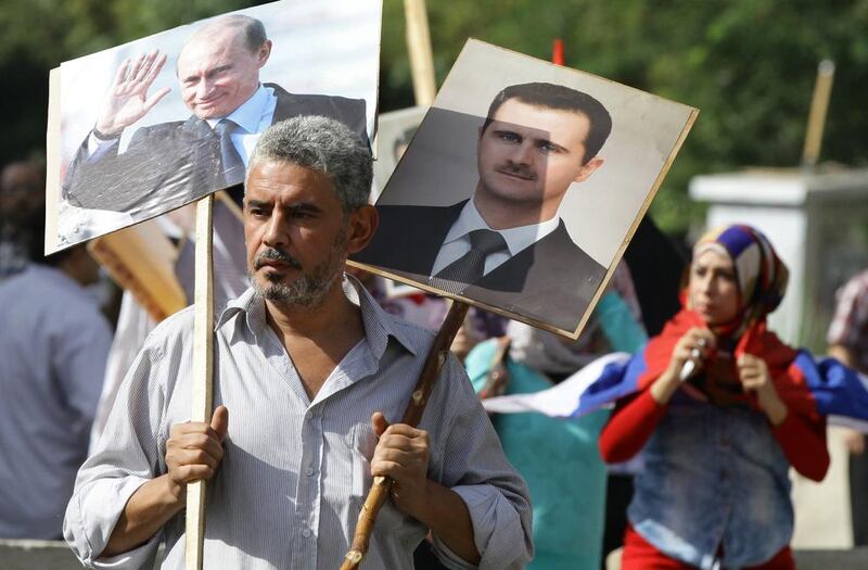 A Syrian man shows his support at a pro-Russia demonstration at the Russian embassy in Damascus. Louai Beshara / AFP