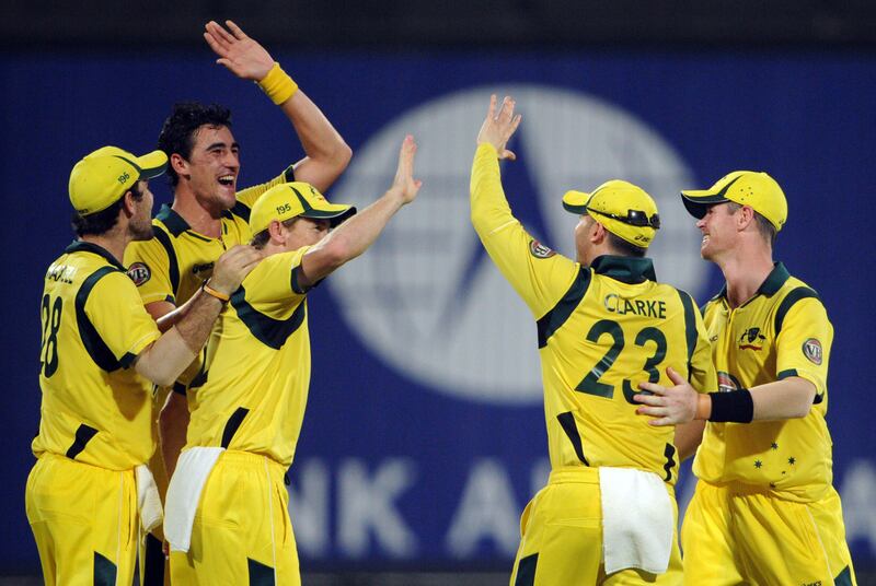 Australian bowler Mitchell Starc (2nd L) celebrates with teammates after taking the wicket of Pakistani batsman Umar Akmal during the first One Day International cricket match between Pakistan and Australia at the Sharjah cricket stadium on August 28, 2012. Pakistan were restricted to 198 in the 45th over in the first of three limited overs international against Australia at Sharjah Stadium. AFP PHOTO / AAMIR QURESHI
 *** Local Caption ***  326841-01-08.jpg