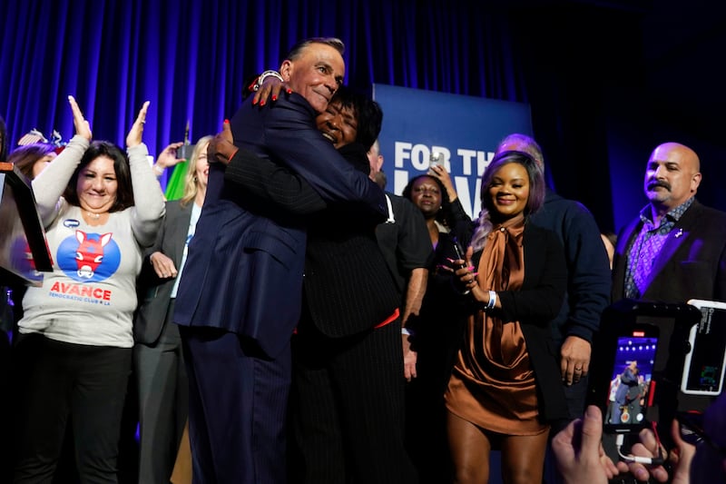 Los Angeles mayoral candidate Rick Caruso gets a hug on stage at his election night headquarters in Los Angeles.  AP