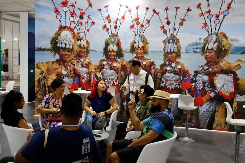 Participants and delegates meet in the Pacific Island pavilion at the Sharm El Sheikh International Convention Centre, on the first day of Cop27. AFP