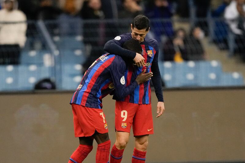 Robert Lewandowski (r) celebrates with Ousmane Dembele after putting Barca ahead in the first half. AP