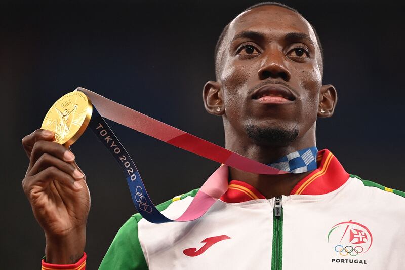 Gold medallist Pedro Pichardo of Portugal poses with his medal  on the podium after the men's triple jump event.