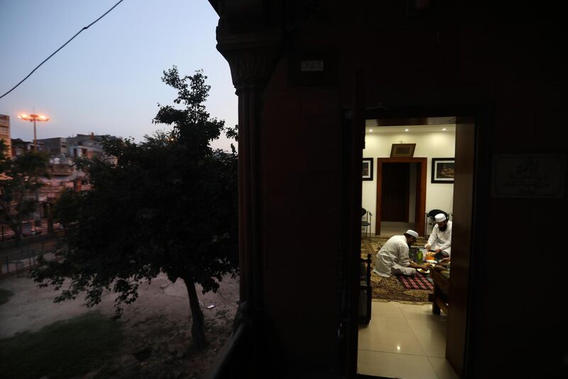 Muslims break fast in the deserted Jama Masjid, usually packed with thousands of devotees during Ramadan, in New Delhi, India. AP