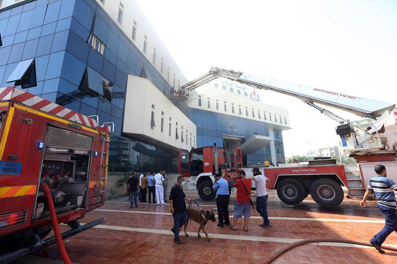 Firefighters and rescuers at the scene. AFP