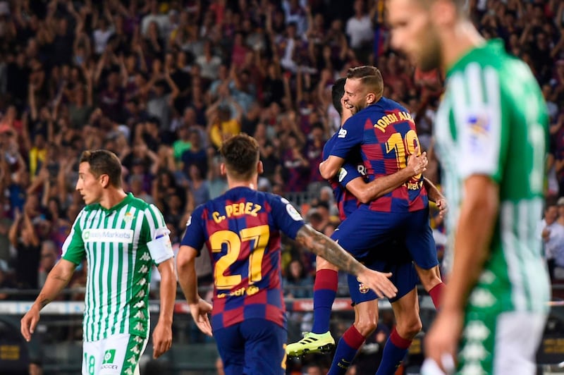 Barcelona's Spanish defender Jordi Alba celebrates with teammates after scoring against Betis. AFP