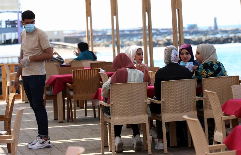 Women chat while enjoy their time at a beach side cafe in Gaza City. AP Photo