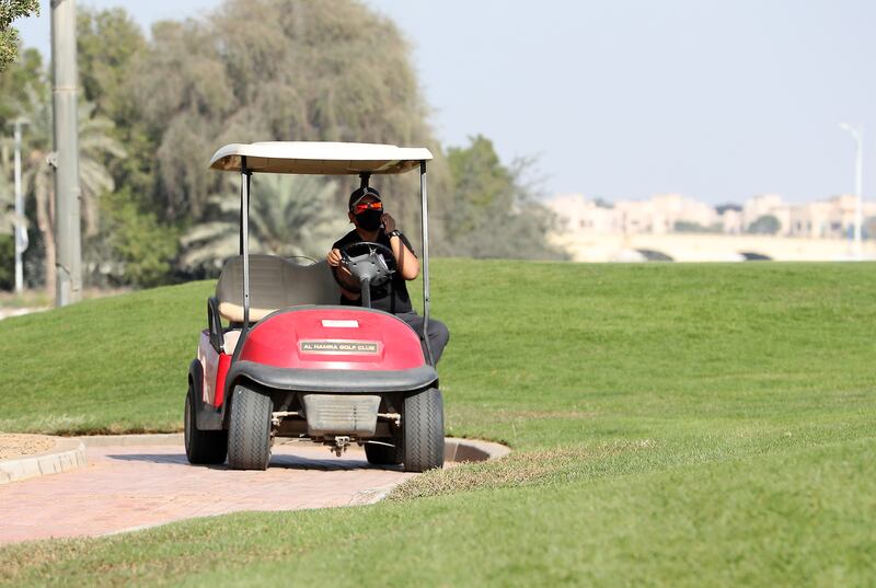 Dindy Macatlang, golf course superintendent, drives a buggy around Al Hamra Golf Club in Ras Al Khaimah. 