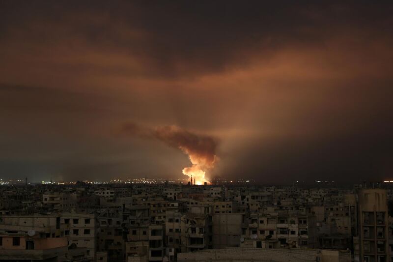 TOPSHOT - Smoke billows following a regime air strike on the besieged Eastern Ghouta region on the outskirts of the capital Damascus, late on February 23, 2018.
Syrian regime air strikes and artillery fire hit the rebel-held enclave of Eastern Ghouta for a sixth straight day killing 32 civilians, as the world struggled to reach a deal to stop the carnage. / AFP PHOTO / Ammar SULEIMAN
