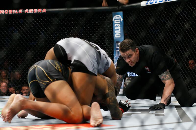 Julianna Pena, top, submits Amanda Nunes during their women's bantamweight title bout. AP Photo