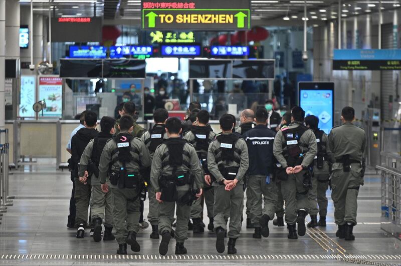 Police officers wearing facemasks as a preventative measure following a coronavirus outbreak which began in the Chinese city of Wuhan patrol at Shenzhen Bay Port Hong Kong Port Area on February 8, 2020. Hong Kong began enforcing a mandatory two-week quarantine for anyone arriving from mainland China, a dramatic escalation of its bid to stop the deadly new coronavirus from spreading. / AFP / Philip FONG
