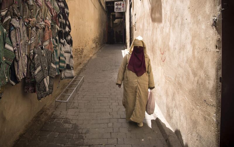A Moroccan woman walks in the 9th century walled medina in the ancient city of Fez on April 11, 2019. AFP
