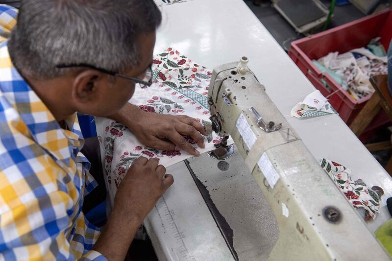 In this photo taken on February 14, 2020, a man works on a sewing machine at the factory of fashion designer Anita Dongre on the outskirts of Mumbai. With stores in India and New York, multiple clothing brands and a global celebrity following, fashion designer Anita Dongre is a feminist powerhouse in a male-dominated industry. But her true ambition is to create an environmentally sustainable company, she says. - TO GO WITH Women-activism-India-fashion-economy-environment,INTERVIEW by Ammu Kannampilly
 / AFP / Laurène Becquart / TO GO WITH Women-activism-India-fashion-economy-environment,INTERVIEW by Ammu Kannampilly
