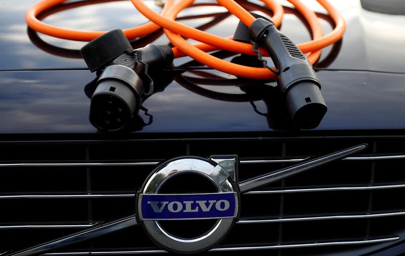 FILE PHOTO: An electric vehicle charging cable is seen on the bonnet of a Volvo hybrid car in this picture illustration taken July 6, 2017. REUTERS/Phil Noble/File Photo