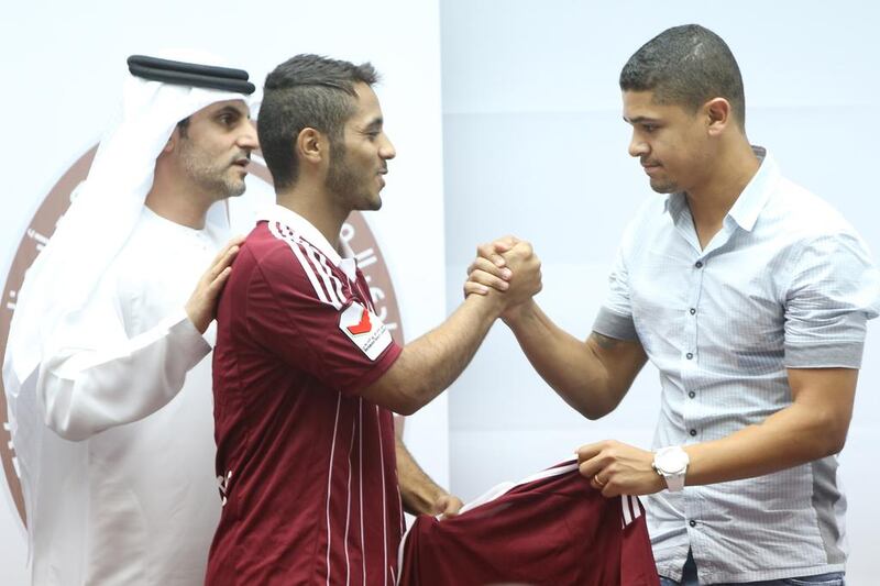 Brazilian Denilson, right, was introduced at a news conference on July 19, 2015, by Al Wahda, with teammate Bader Al Harthi welcoming him as the newest team member. DELORES JOHNSON / The National 
