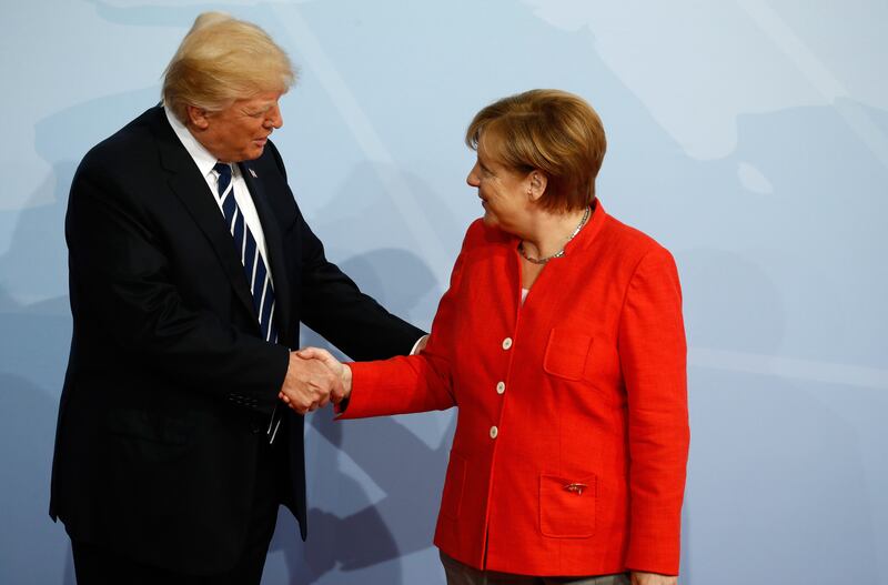 German chancellor Angela Merkel welcomes US president Donald Trump as he arrives to attend the G20 summit in Hamburg.  Odd Andersen / AFP