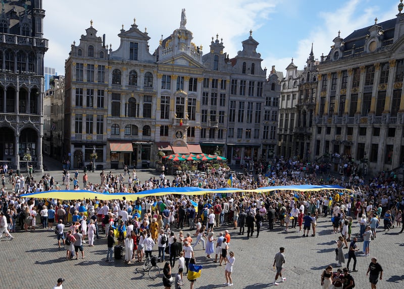 A vast Ukrainian flag is unfurled on Independence Day in the historical Grand Place of Brussels. AP