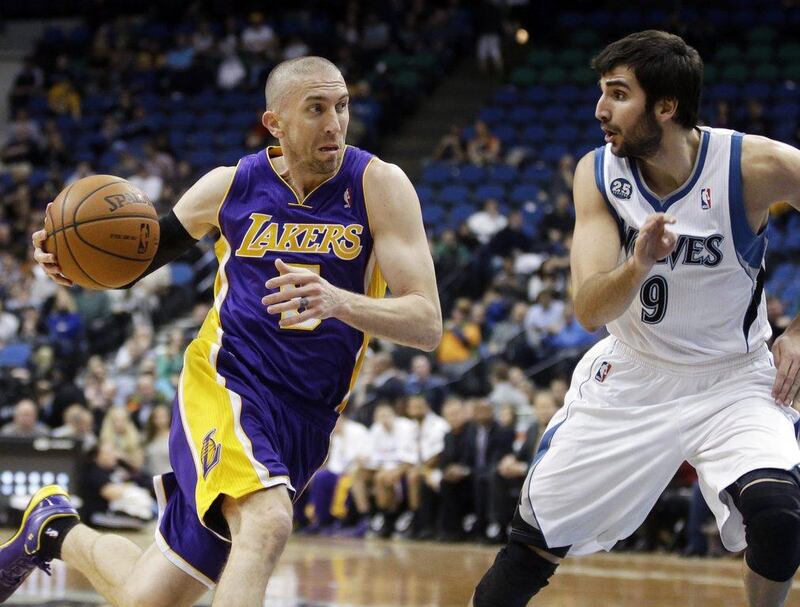 Los Angeles Lakers' Steve Blake, left, recorded his first career triple-double on Wednesday night as the Lakers edged past the Cleveland Cavaliers. AP Photo/Jim Mone
