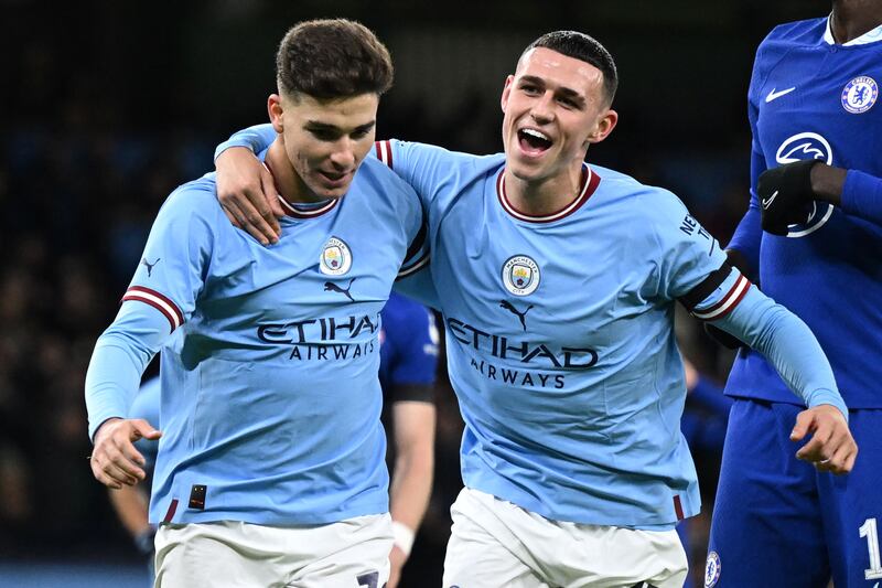 Manchester City striker Julian Alvarez (L) celebrates with  Phil Foden after scoring their second goal in the 4-0 FA Cup victory against Chelsea at the Etihad Stadium on January 8, 2023. AFP