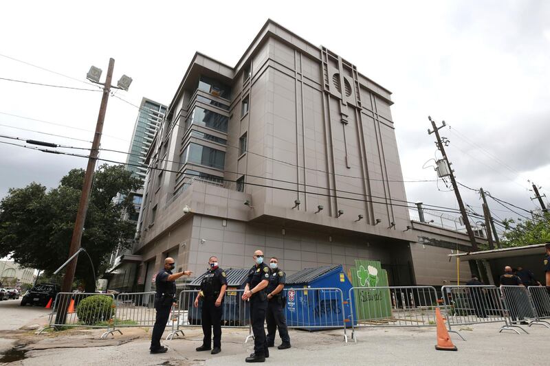 Police officers install barricades outside the Consulate General of China. Houston Chronicle via AP