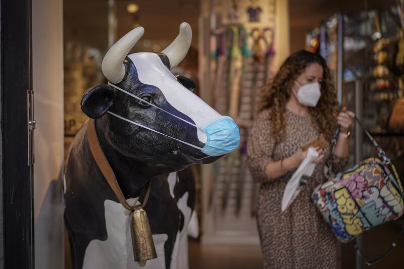 A novelty cow figure stands at the entrance to a clothing and accessories store in Madrid, Spain. Bloomberg