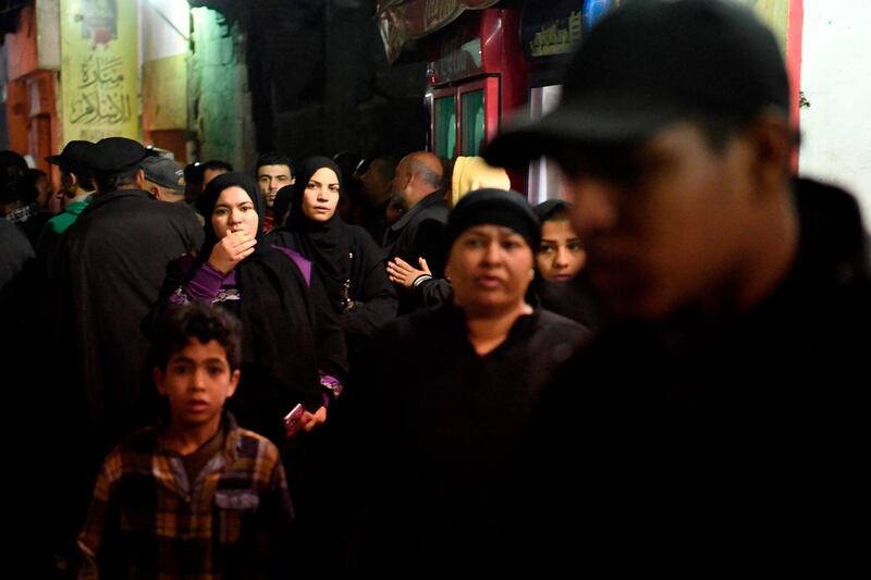 Members of the public crowd together at the site. AFP