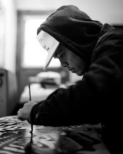 Artist DJ Javier at work in his studio. He hand-paints all of his designs. Photo: DJ Javier