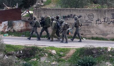 Israeli soldiers take positions during an operation to demolish homes belonging to Palestinians accused of killing an Israeli soldier, in the West Bank village of Kafr Dan, near Jenin city. EPA