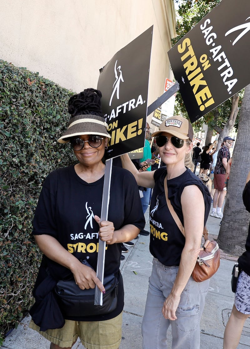Yvette Nicole Brown, left, protests outside Warner Bros Studios in Burbank, California. Getty Images