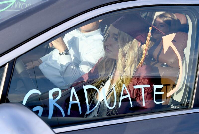 Graduate Anna Massari listens to a commencement speech in a car during a graduation ceremony for Faith Lutheran High School held at Las Vegas Motor Speedway due to the spread of the coronavirus in Las Vegas, Nevada. AFP