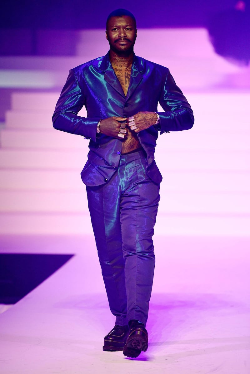 French football player Djibril Cisse walks the runway for Jean Paul Gaultier's final show in Paris. AFP