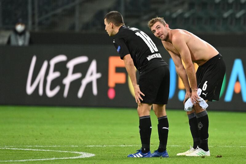 Moenchengladbach's Austrian defender Stefan Lainer (L) and Moenchengladbach's German midfielder Christoph Kramer at the final whistle. AFP