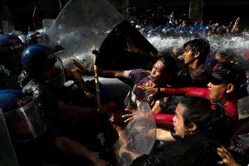 Protesters clash with anti-riot police officers as they try to march towards the US embassy during a rally against US president Donald Trump's visit, in Manila, Philippines. Athit Perawongmetha / Reuters