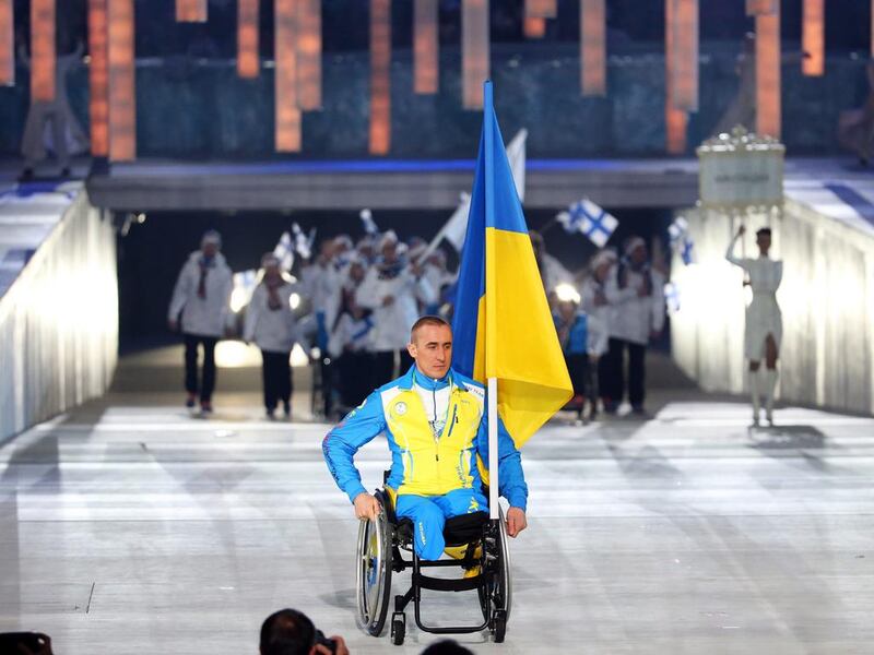 Flag bearer Mykhailo Tkachenko of Ukraine makes his entrance at Friday night's Paralympic Games opening ceremonies. Sergei Chirikov / EPA / March 7, 2014