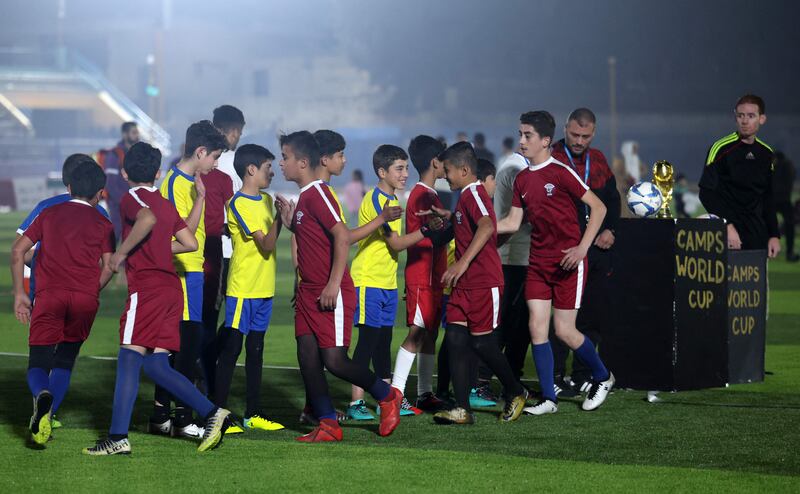 Children shake hands after the game