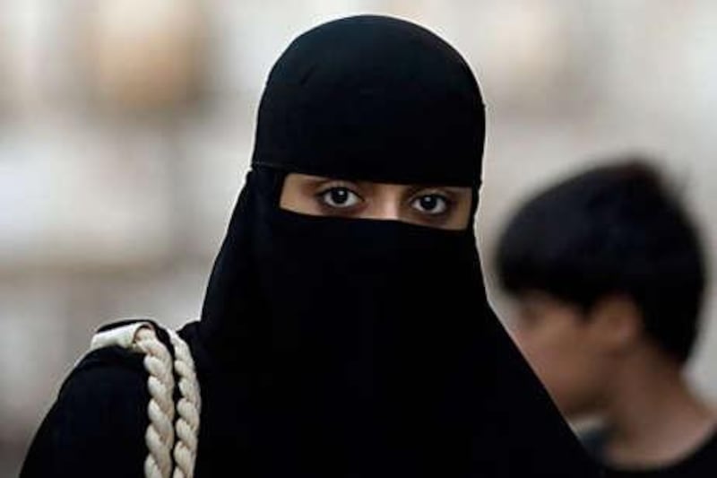 A woman wears the niqab, above, an uncommon sight in Damascus, where most Syrians prefer to wear a hijab, below. The education ministry has banned women who wear niqabs from teaching in primary schools, saying it undermines Syria's tradition of a secular education system.