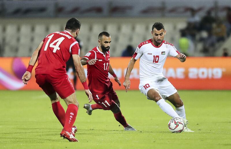 SHARJAH , UNITED ARAB EMIRATES , January  6 – 2019 :- Sameh Maraaba ( no 10 in white ) of Palestine and Osama Omari ( no 11 in red ) of Syria in action during the AFC Asian Cup UAE 2019 football match between Syria vs Palestine held at Sharjah Football Stadium in Sharjah. ( Pawan Singh / The National ) For News/Sports